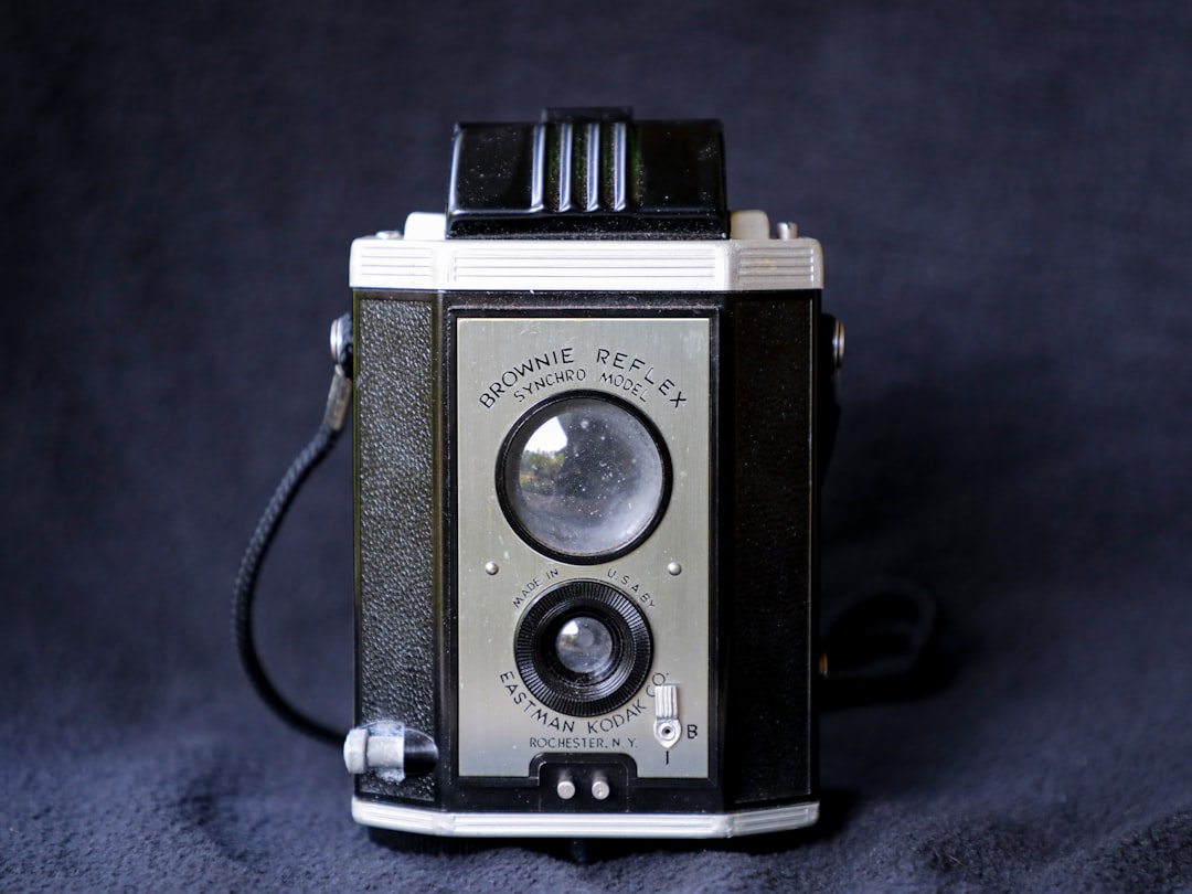 black and silver camera on blue textile
