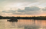 Sunset casting golden light over West Fox Lake with a pontoon boat docked nearby.