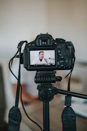 black dslr camera on tripod