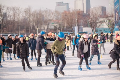 people walking on snow covered field during daytime ice skates google meet background