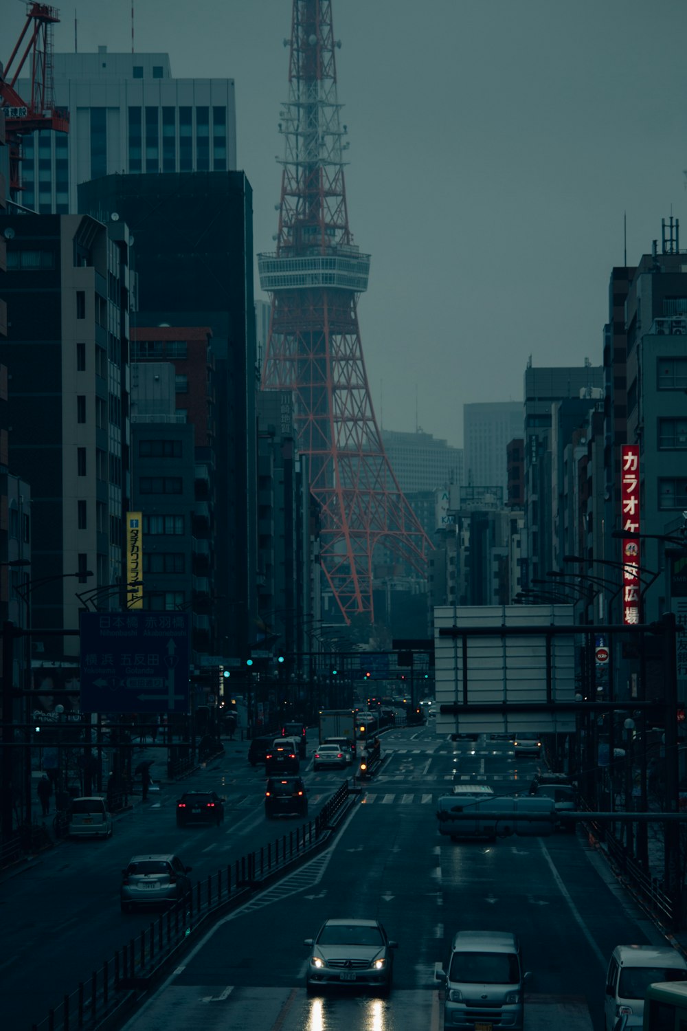 cars on road near high rise buildings during night time