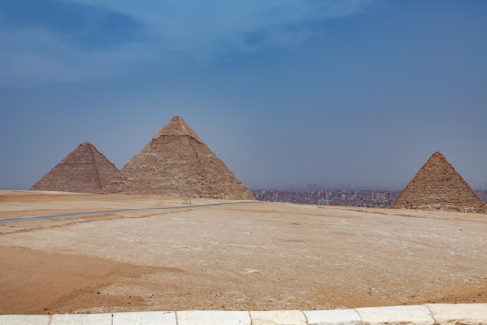 brown pyramid under blue sky during daytime in Giza Necropolis Egypt