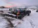 black suv on snow covered ground during daytime
