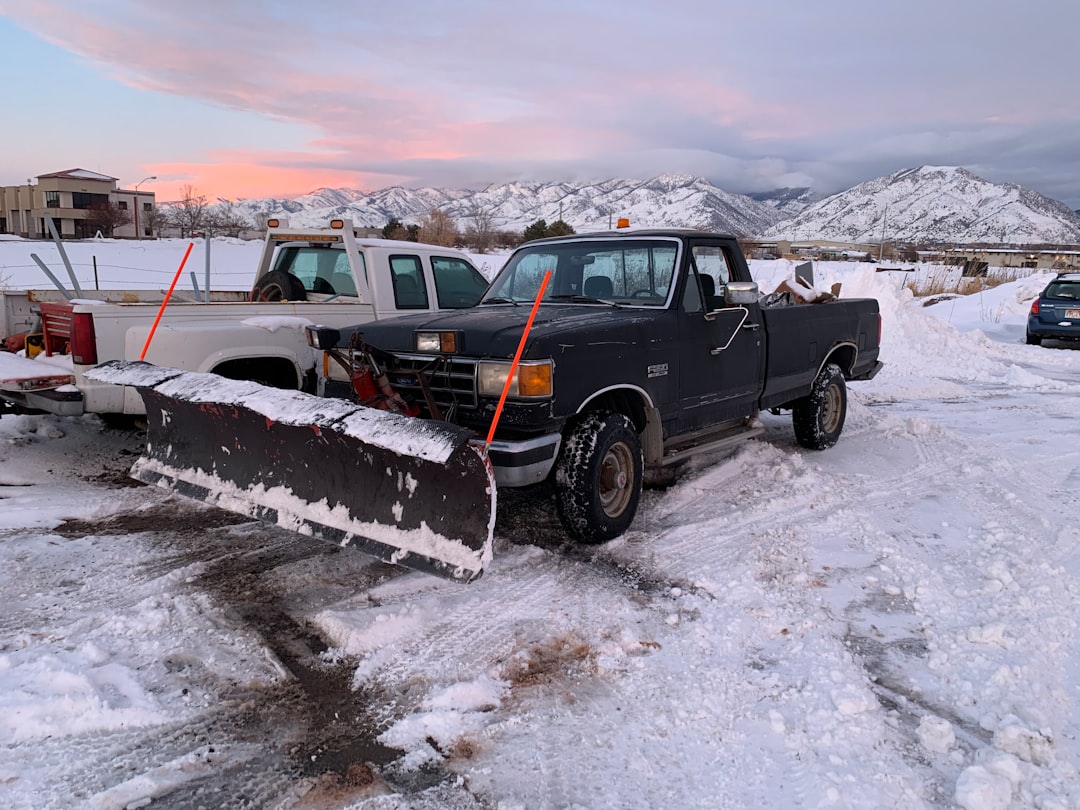 black suv on snow covered ground during daytime