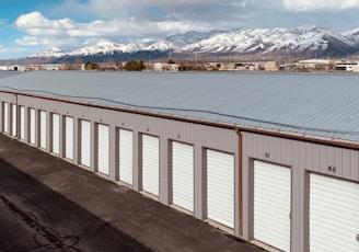 white wooden fence near body of water during daytime