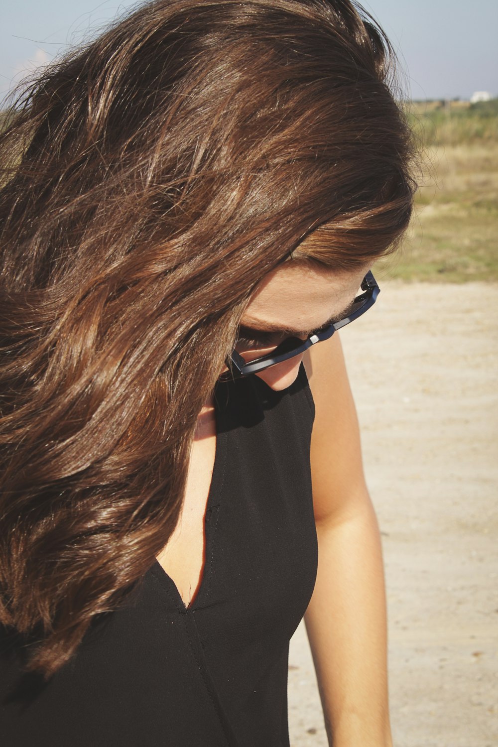 woman in black tank top wearing black framed sunglasses