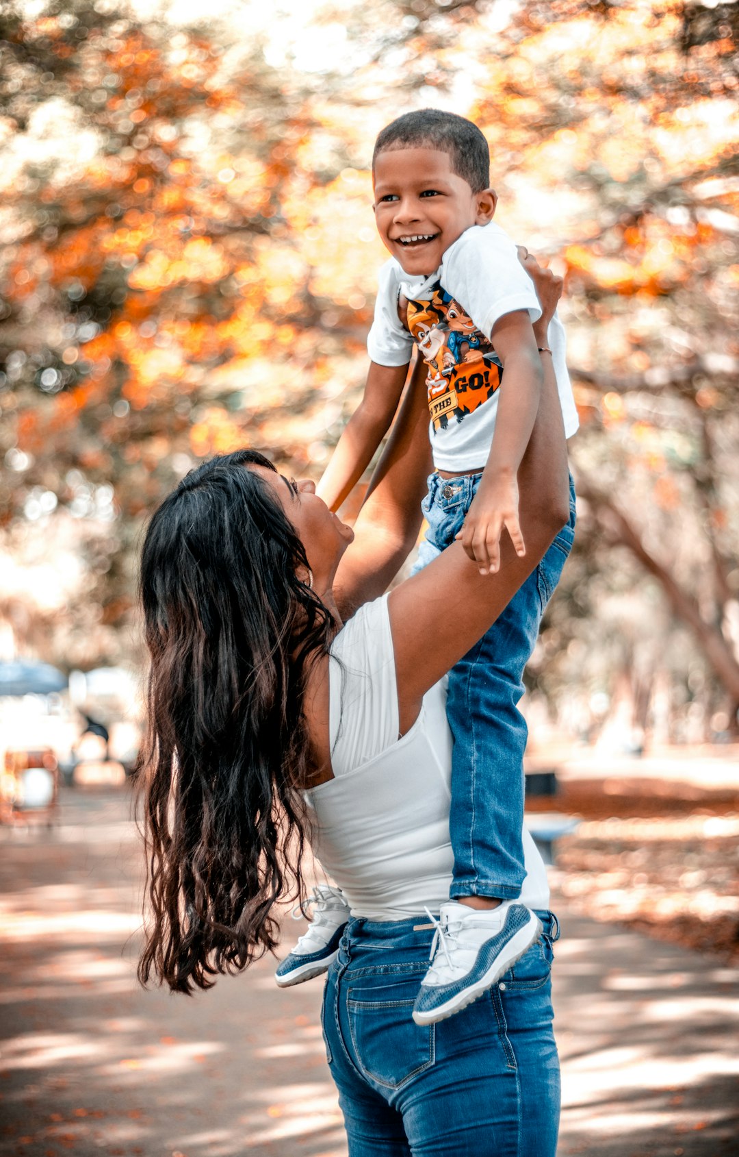 man in white shirt hugging woman in white dress