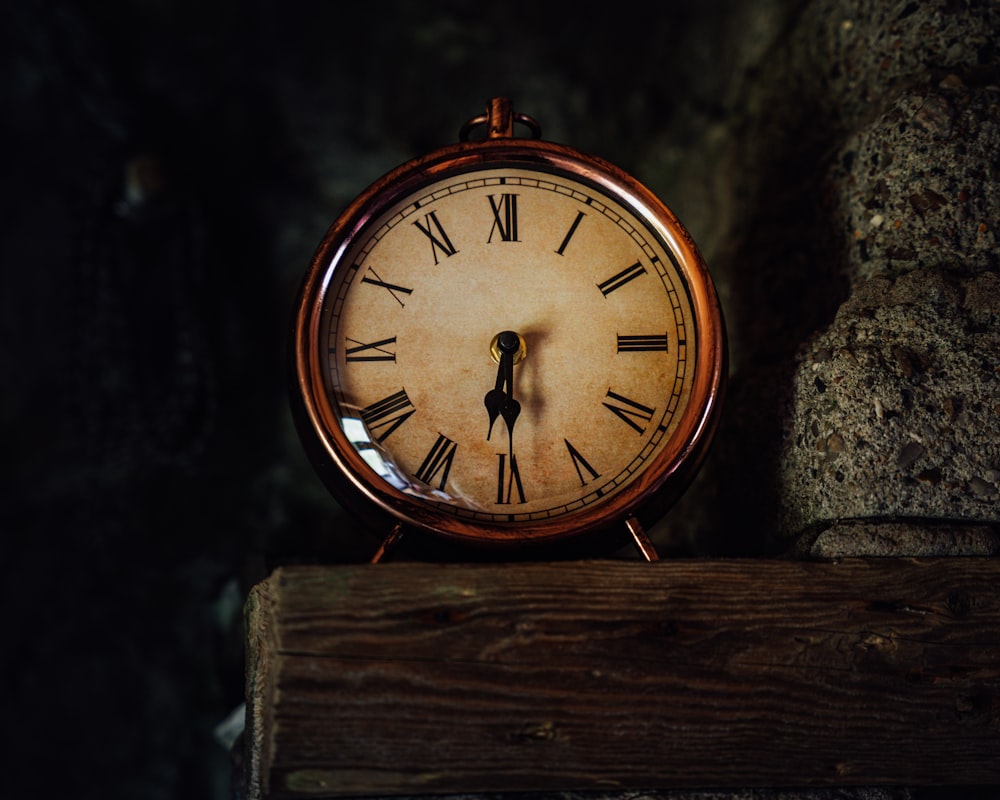 brown wooden round analog wall clock