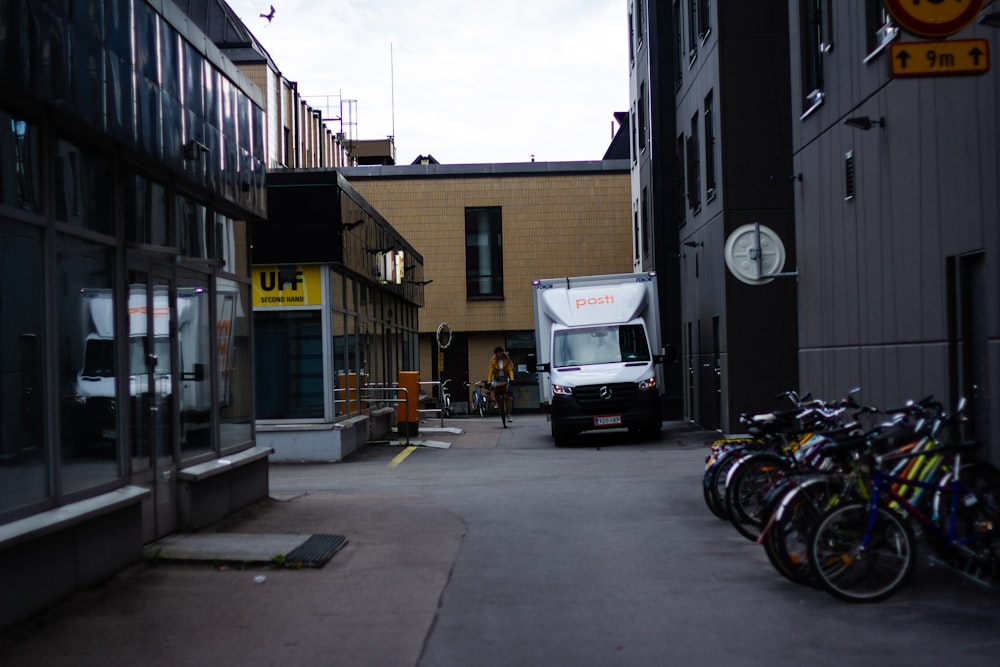 white van parked beside brown concrete building during daytime