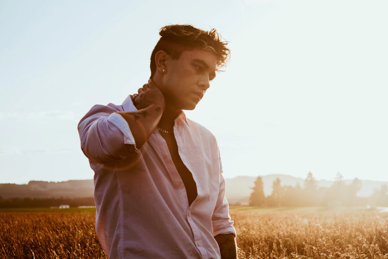 Handsome Gay Sugar Baby in a white shirt outdoors