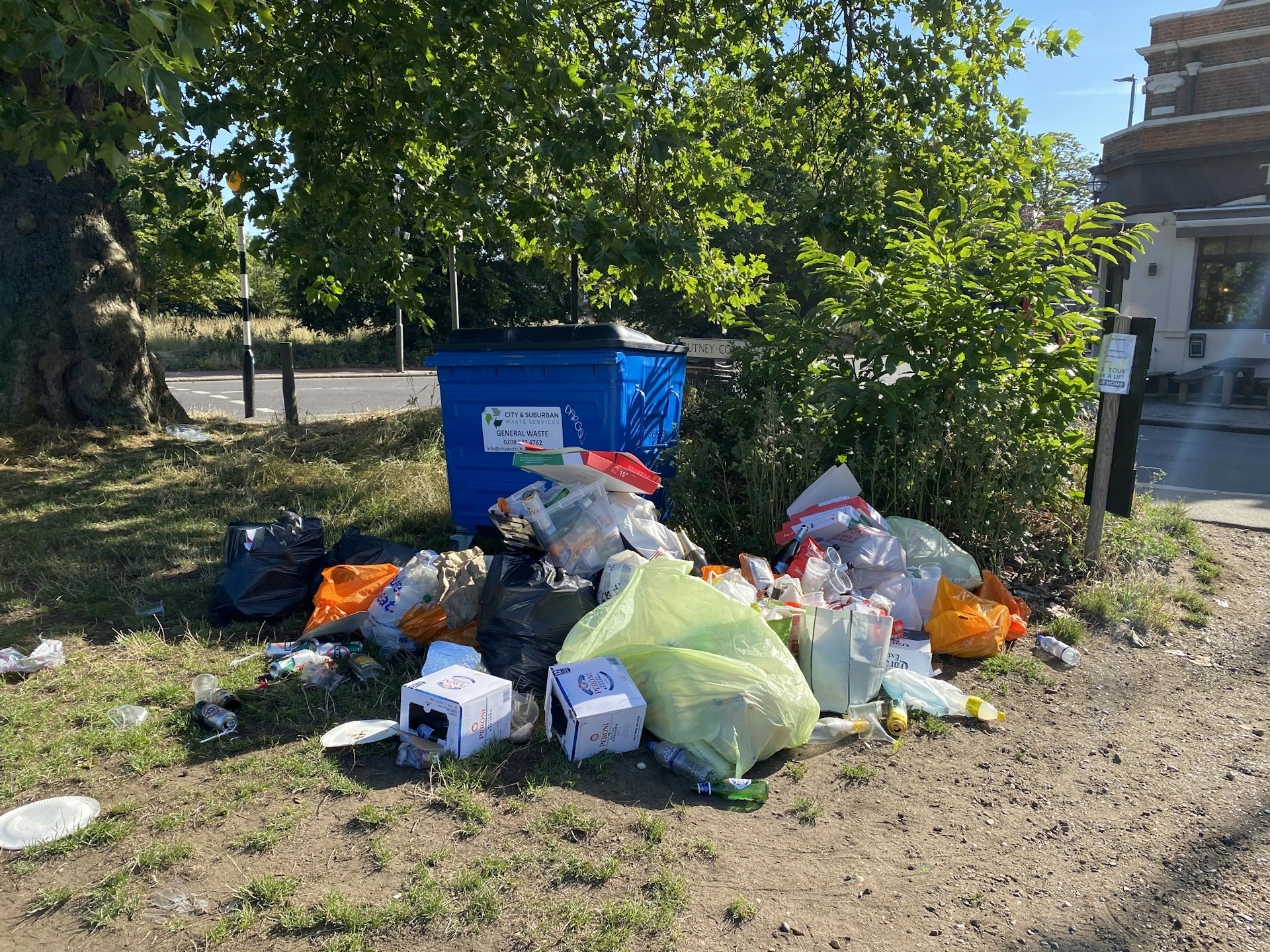 a pile of garbage sitting on the side of a road