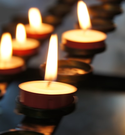 lighted candles on black metal candle holder