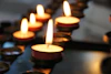 lighted candles on black metal candle holder