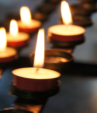 lighted candles on black metal candle holder