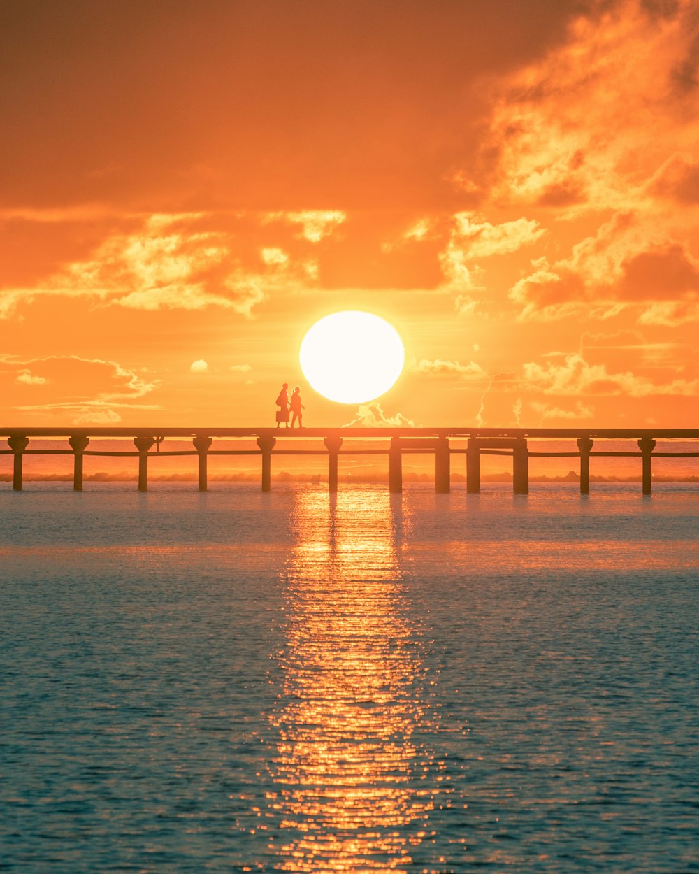 bridge over the sea during sunset