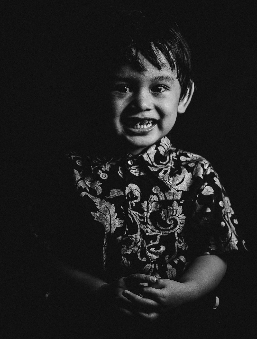 grayscale photo of smiling boy