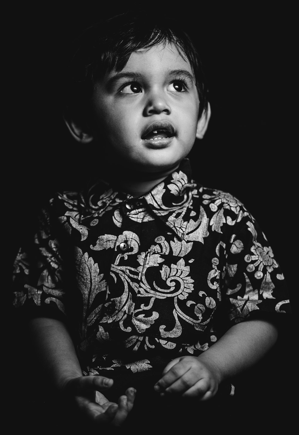 grayscale photo of child wearing floral shirt