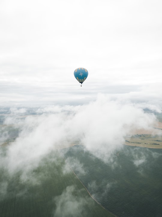 blue hot air balloon on mid air under white clouds during daytime in Suzdal Russia