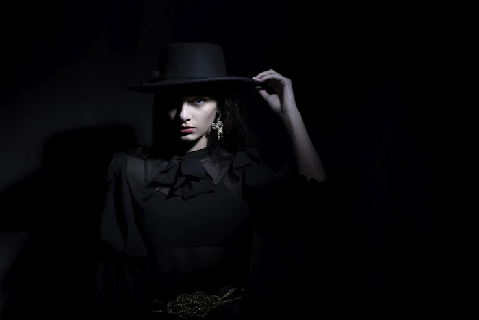 Editorial portrait in black hat
