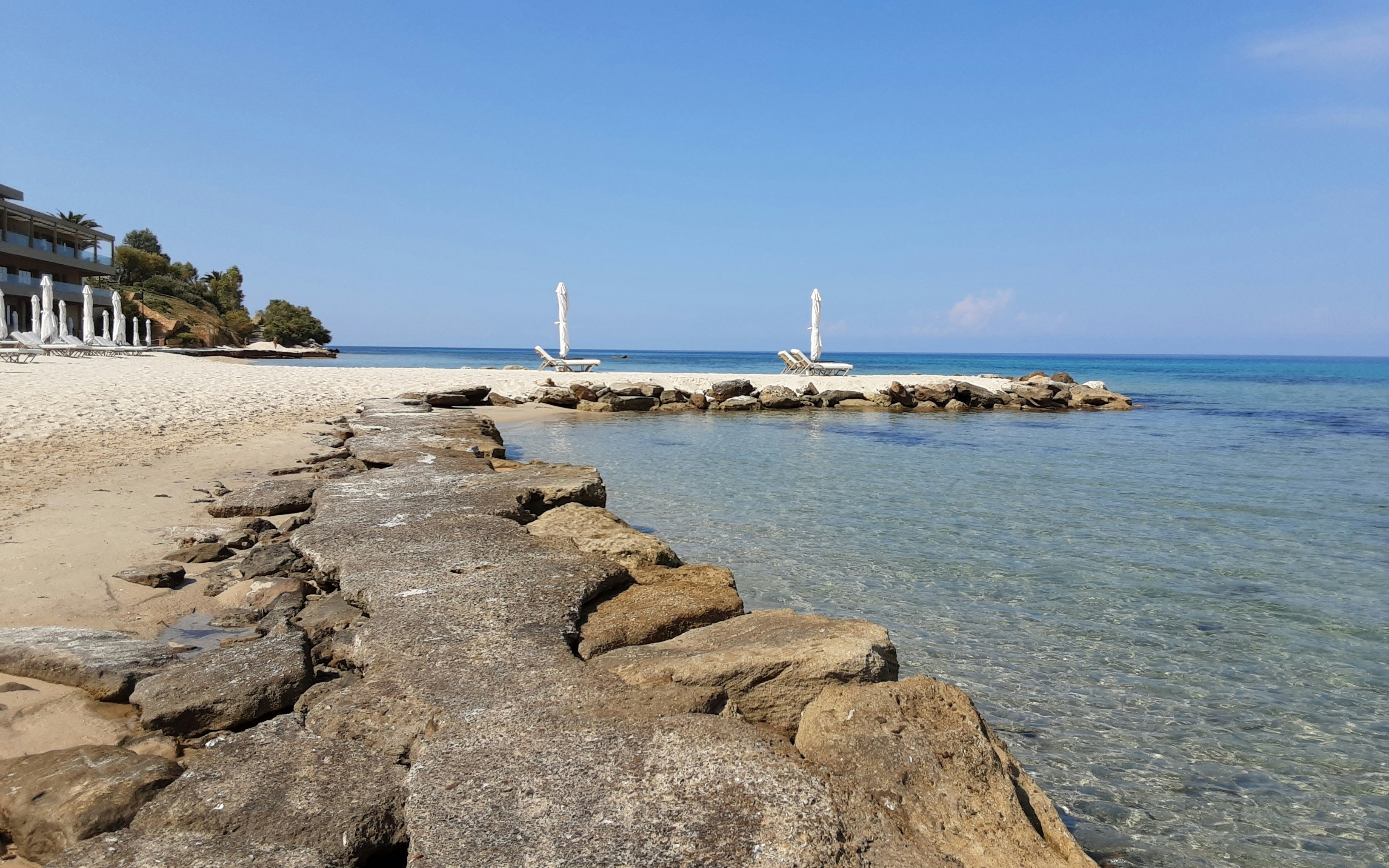 Private beach access with sun loungers and crystal clear water