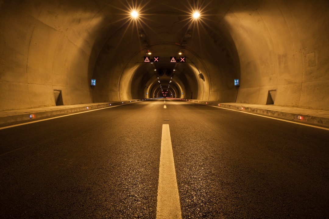 empty tunnel with lights turned on during night time