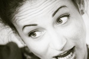 grayscale photo of womans face