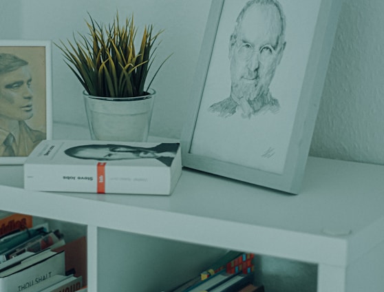 white framed woman portrait on white wooden shelf