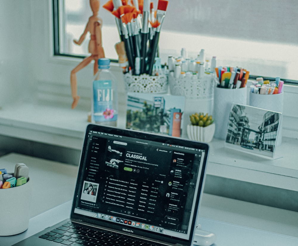 black and silver laptop computer on white table