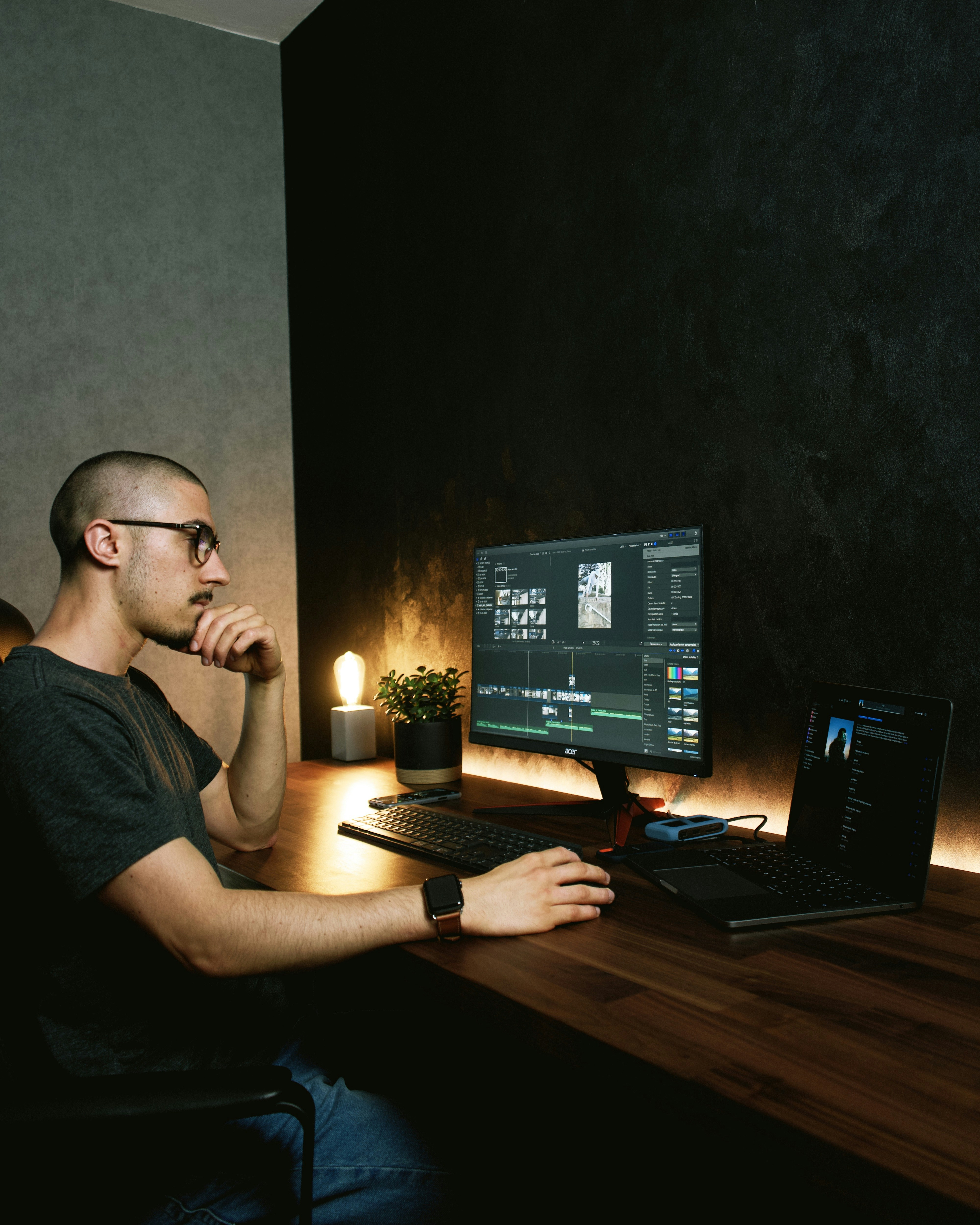 man in gray crew neck t-shirt sitting in front of black flat screen computer monitor