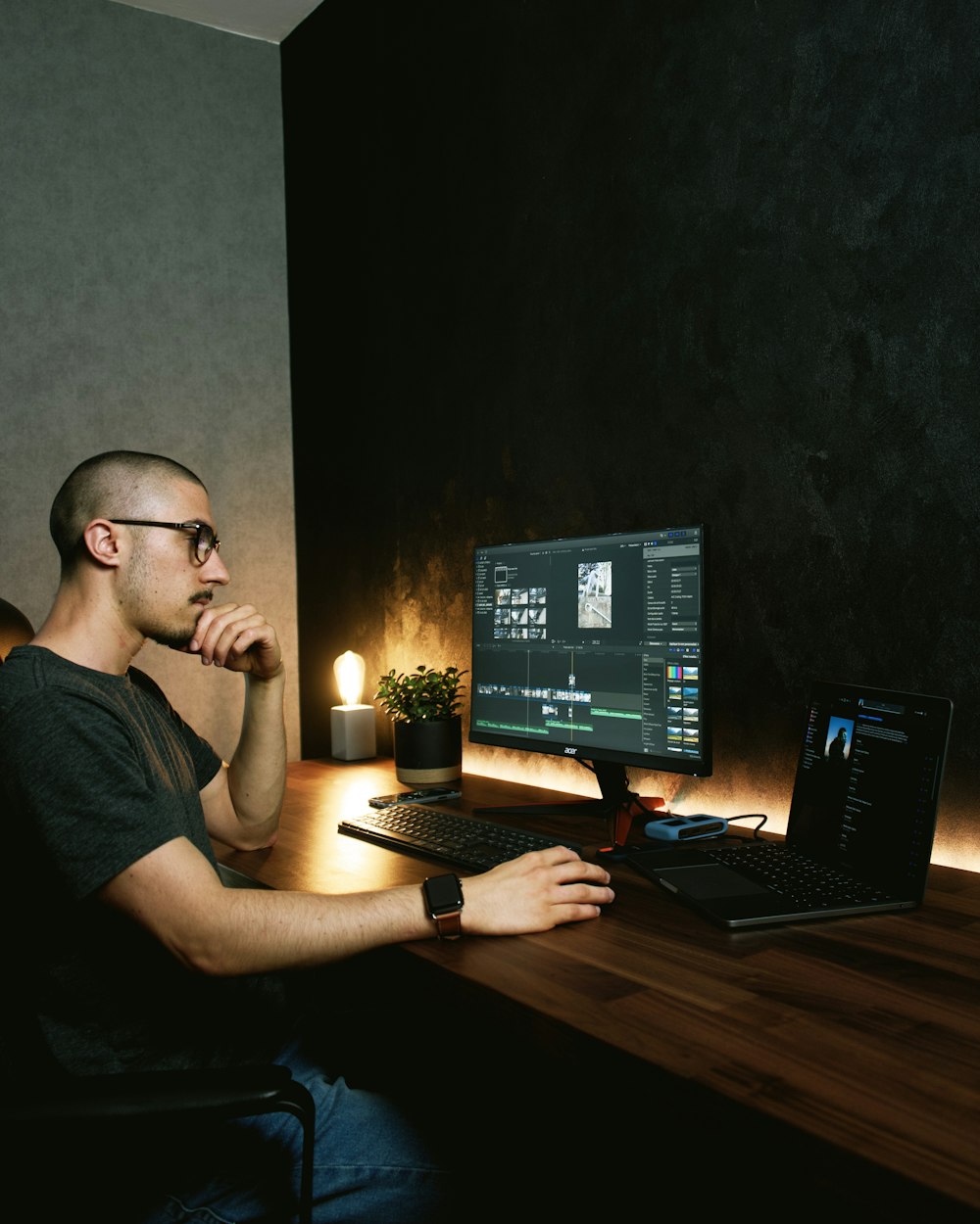 man in gray crew neck t-shirt sitting in front of black flat screen computer monitor