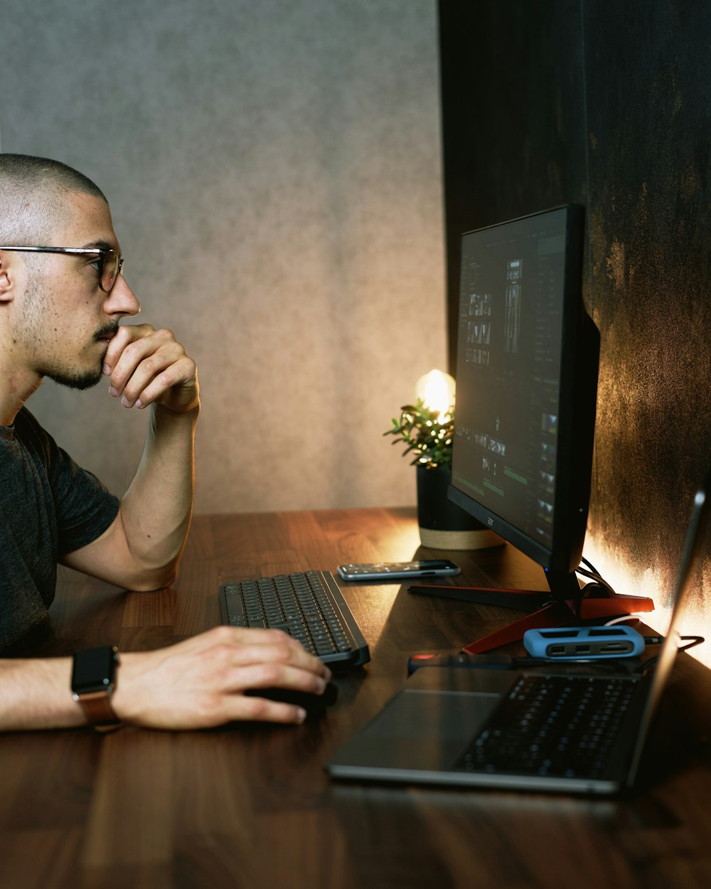 man in gray crew neck t-shirt using computer