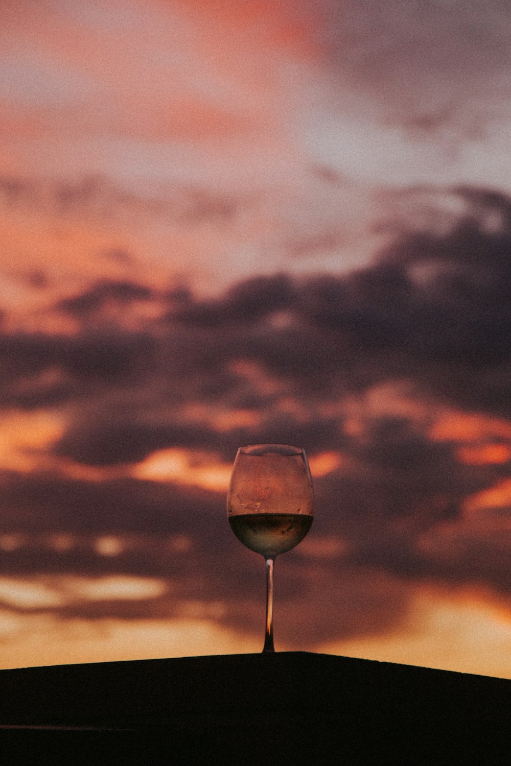 clear wine glass with water during sunset
