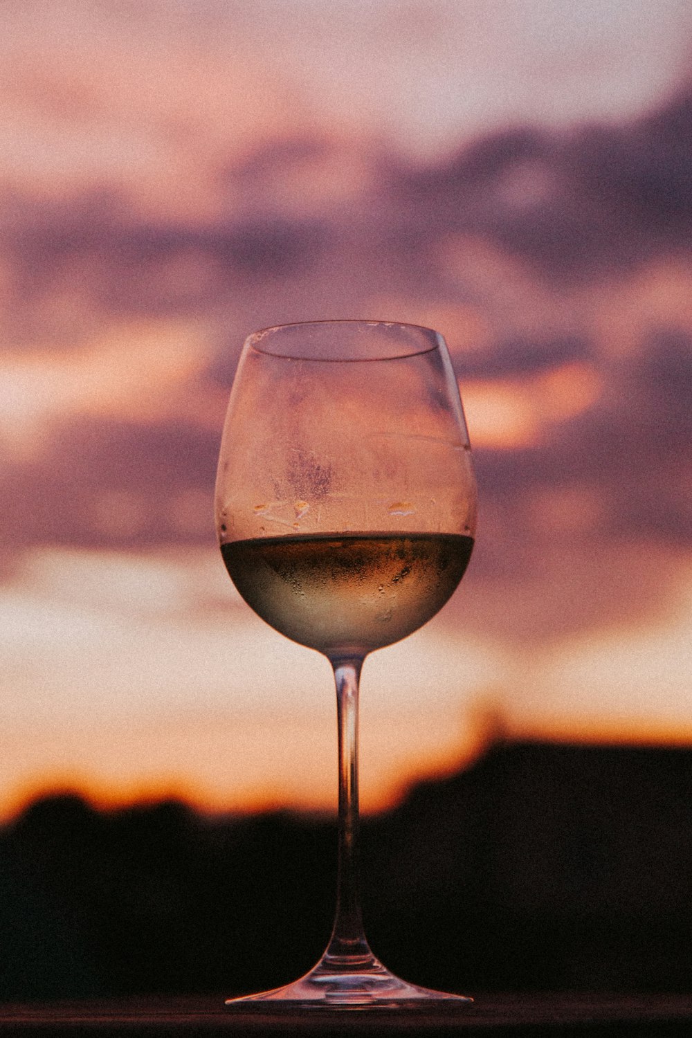 clear wine glass with brown liquid