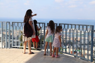 A family enjoying a balcony view.