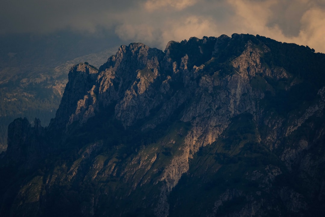 brown and gray rocky mountain under cloudy sky during daytime