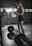 A motivated athlete lifting weights in a bright, modern gym setting.