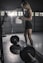woman in black tank top and black shorts holding barbell