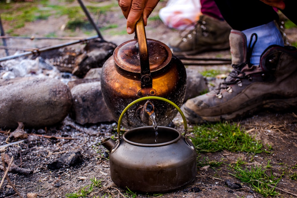 brown kettle on black and gray stone