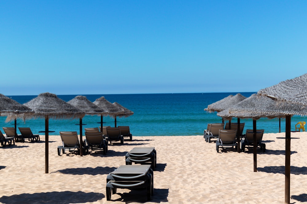 brown wooden chairs on beach during daytime