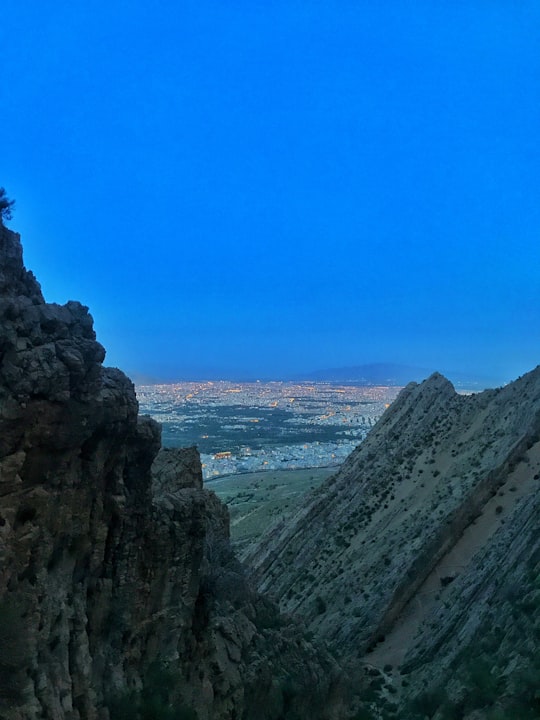 gray rocky mountain under blue sky during daytime in Shiraz Iran