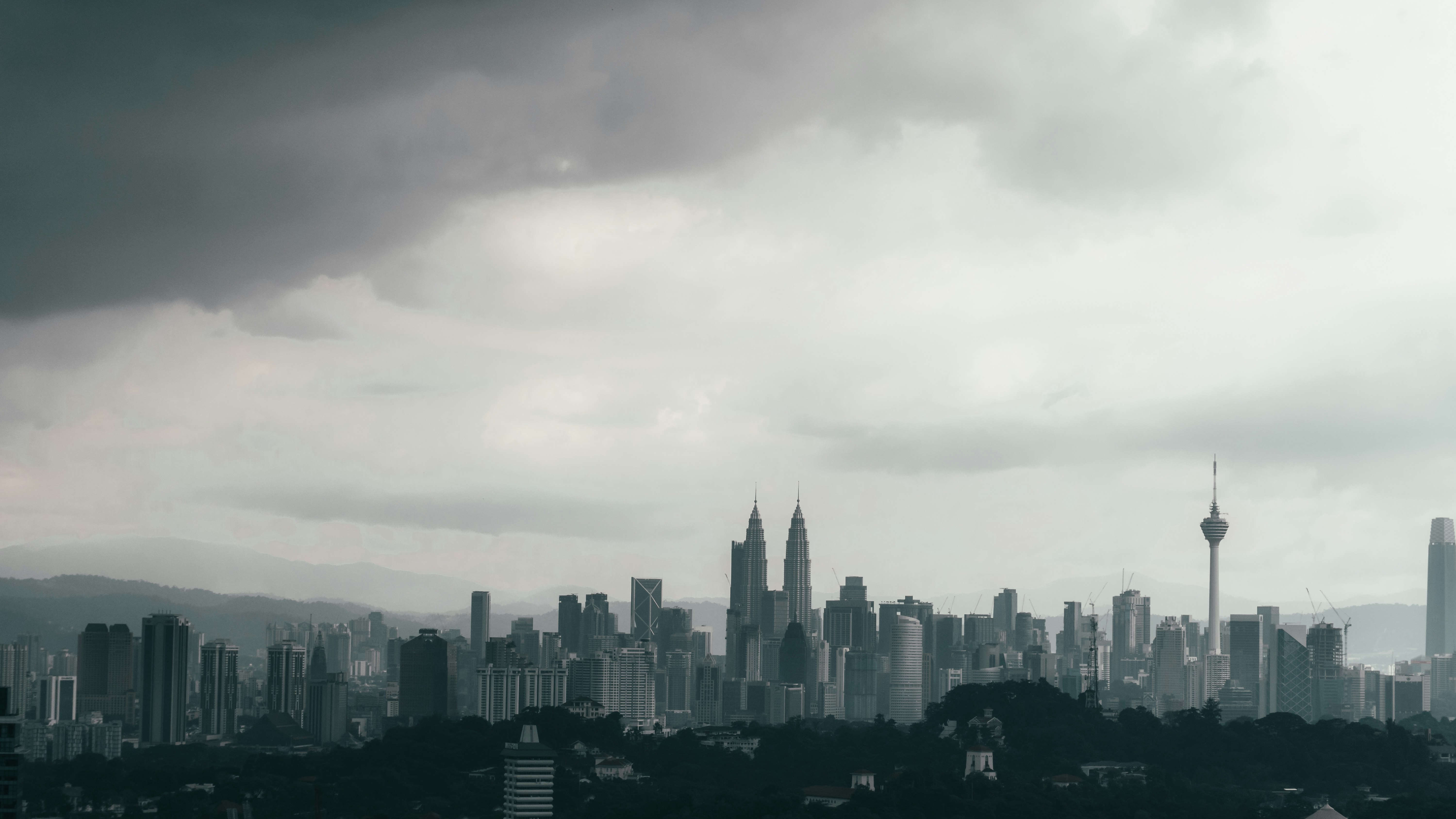 city skyline under white clouds during daytime