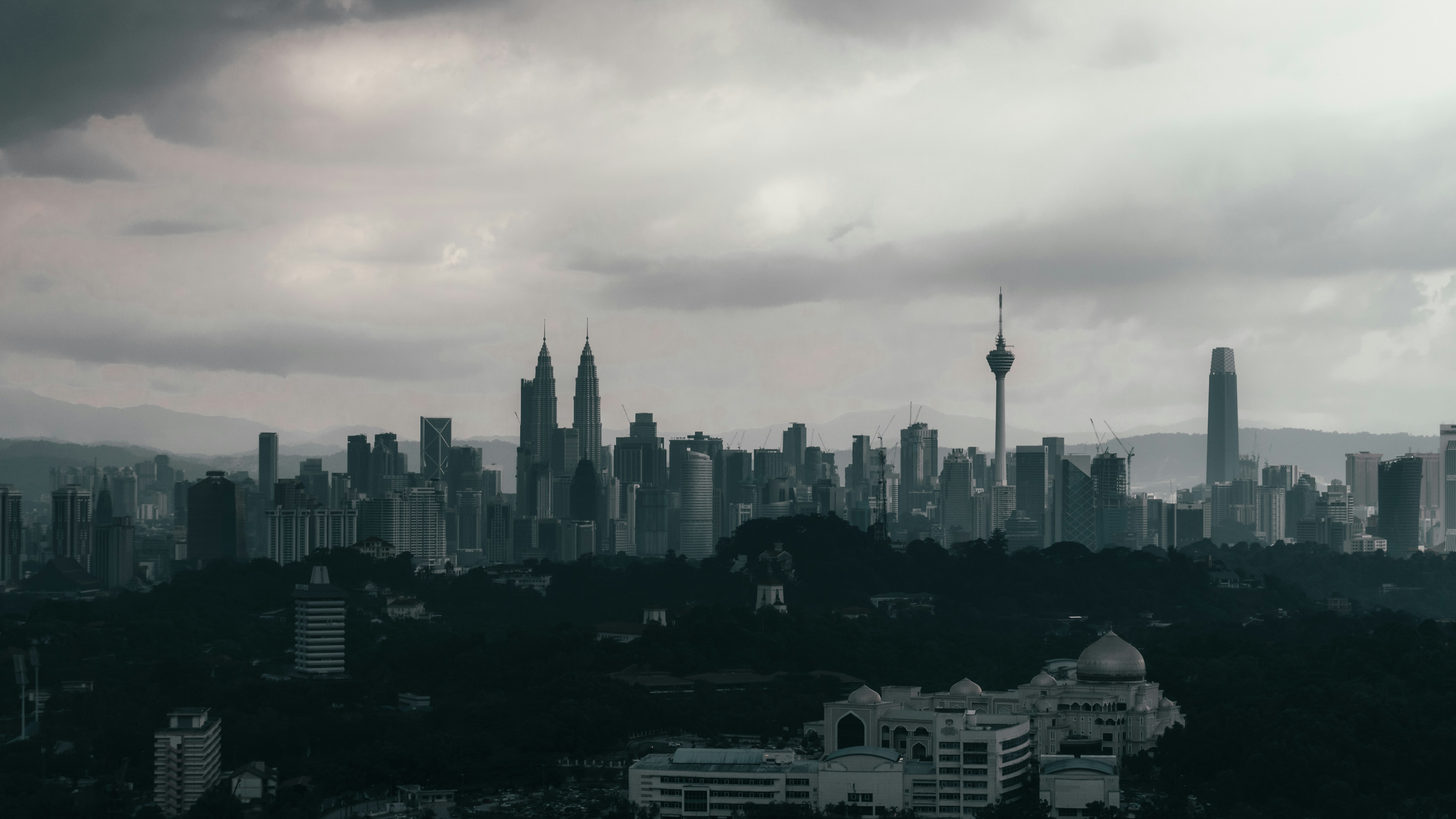 city skyline under white clouds during daytime