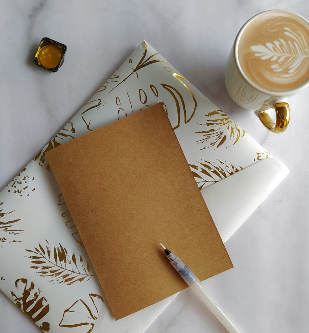 a cup of coffee and a notepad on a table