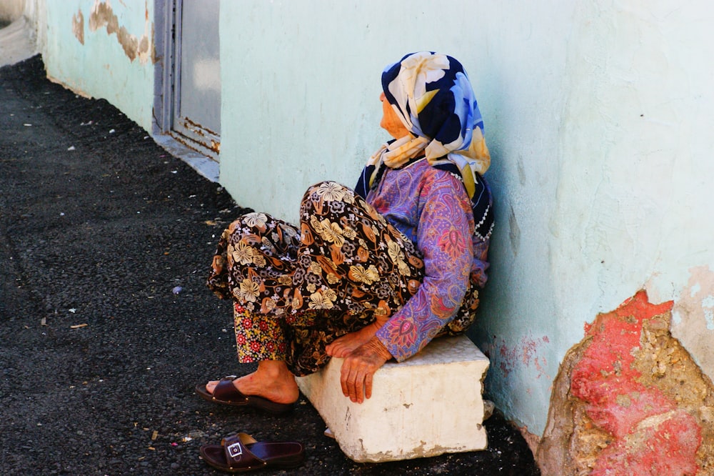 woman in brown and white hijab sitting on floor