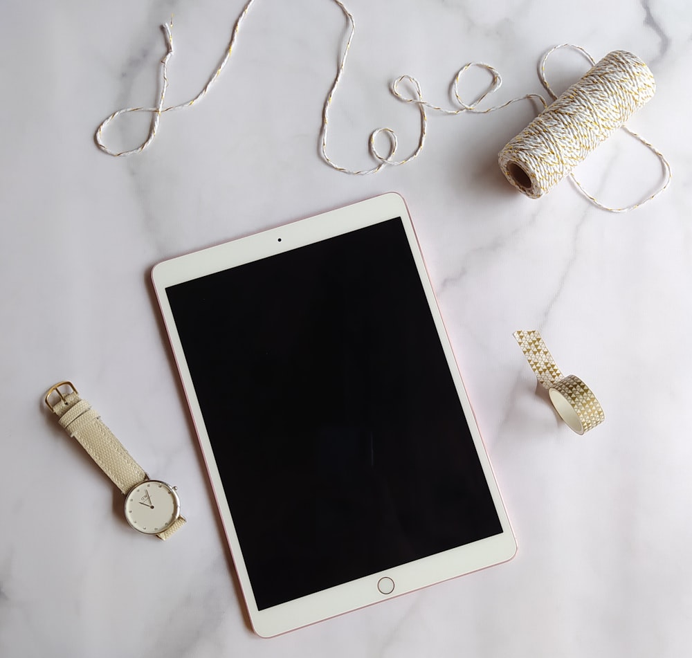 white ipad on white table