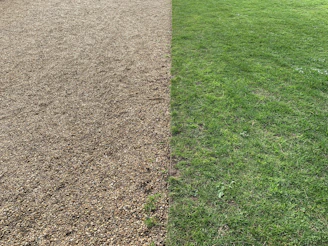 Grass edge separated by a clean plastic lawn strip from decorative gravel area.