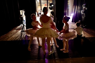 3 women dancing on stage