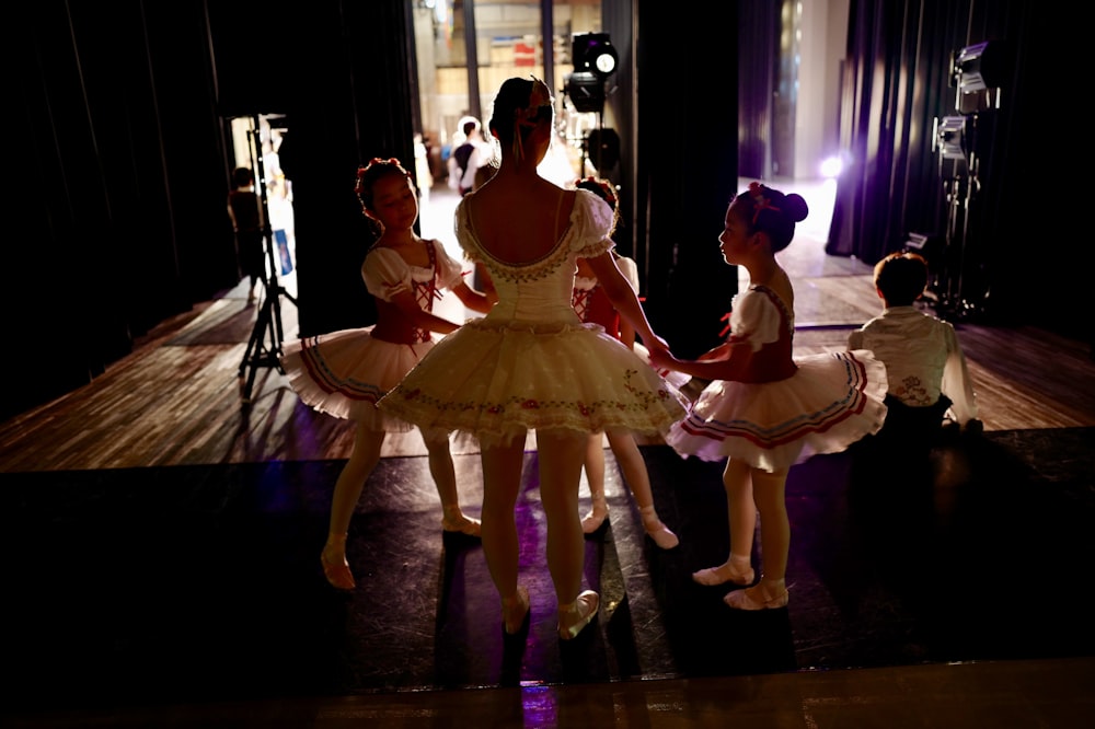 3 women dancing on stage