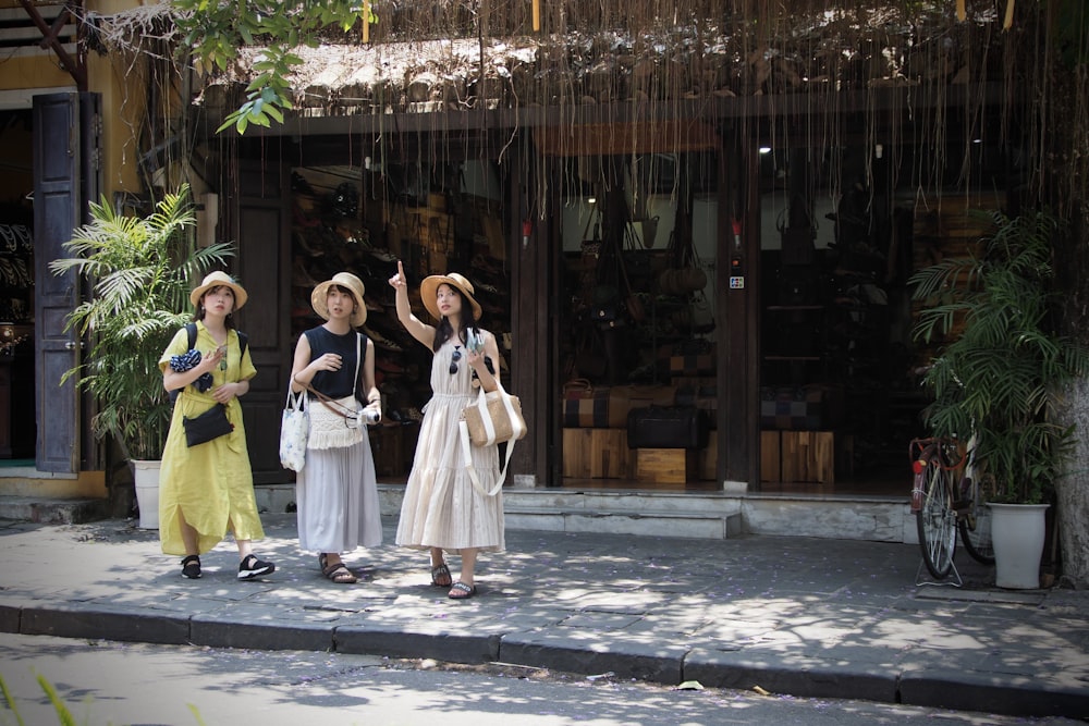 woman in white dress standing beside girl in white dress