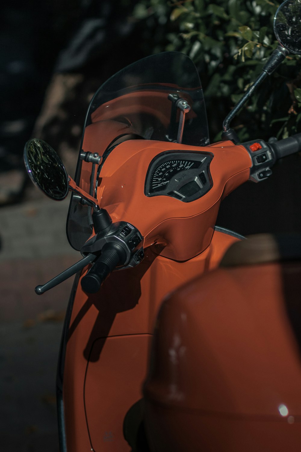 orange and black motorcycle with helmet
